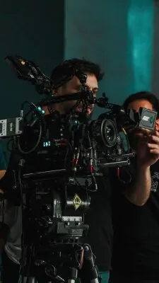 Cinema camera operator working with a professional shoulder-mounted camera rig