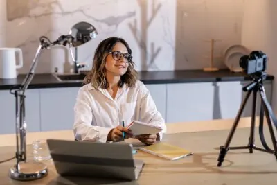 Creator presenting to a camera at a desk for an online video production