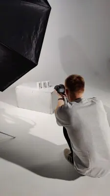 Photographer producing a clean studio product image with controlled lighting